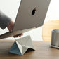 Portable fold-flat laptop stand being carried